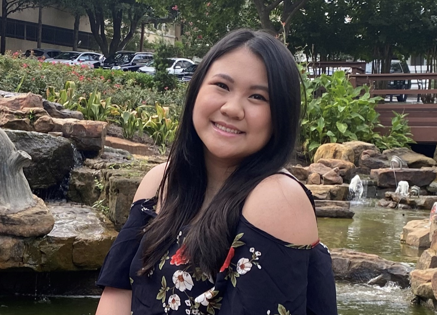 AET '22 graduate Julia Nguyen smiling near an outdoor fountain