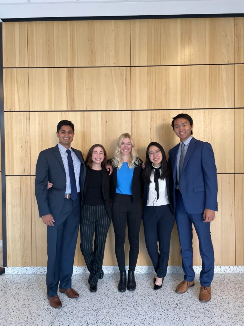 the five members of Scheme Team outside the McCombs graduate school building at UT Austin
