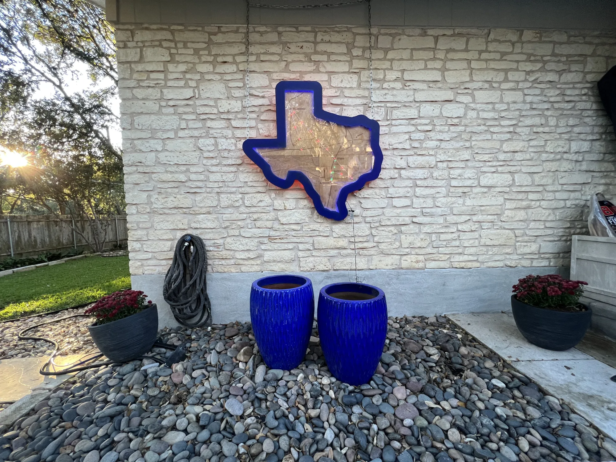 Image of LED-lighted wood cutout of Texas created by undergrad Design student on the outside of his family home