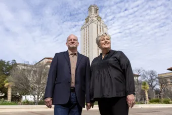 Central Texas philanthropists Karl and Nelda Buckman posing in front of the UT Austin Tower