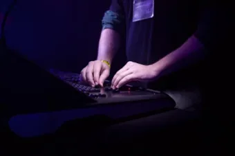 closeup of hands at a lighting board