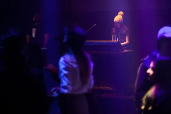 student wearing a winter hat and running a lighting board