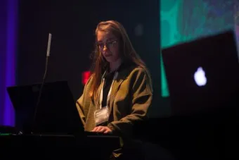 a student standing at a VJ lighting booth