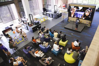 SDCT Students listening to Assistant Dean Doreen Lorenzo at an all-school fall kickoff in The Foundry, located in the Fine Arts Library at UT Austin