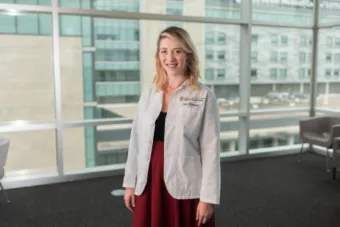Lana Schommer MD MA in Dell Medical School lab coat