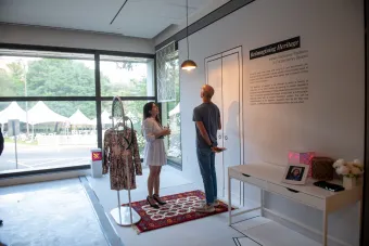 Two Becauseisms attendees interacting with Reimagining Heritage installation