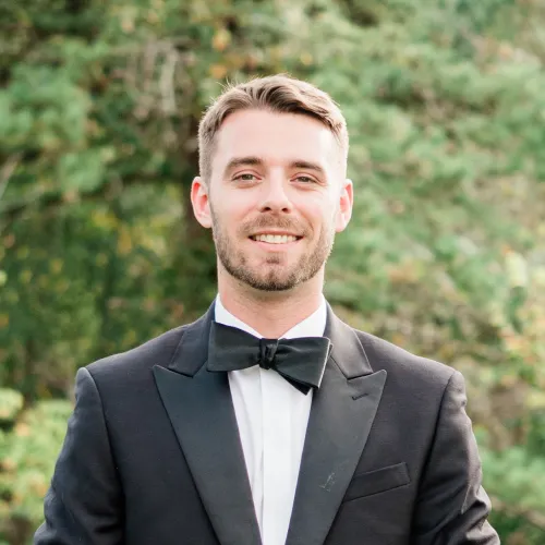 Professional headshot of Mason Hayes smiling in an outdoor setting
