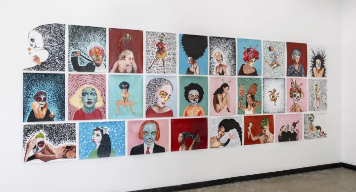 A wall installation of 25 mixed-media artworks arranged in a grid pattern. Each piece features surreal and expressive portraits of figures with Day of the Dead-inspired makeup, abstract backgrounds, and handwritten text elements. The collection incorporates bold colors, intricate patterns, and symbolic imagery, exploring themes of identity, transformation, and cultural heritage.