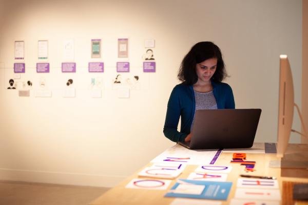 design student working on laptop at the Spring 2019 design exhibition