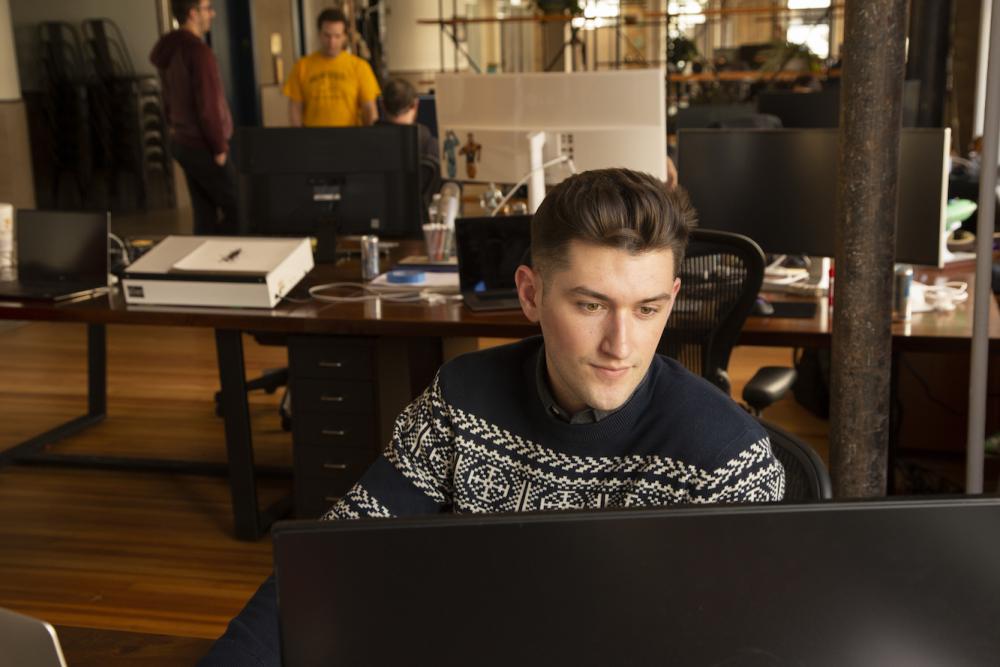 CID student Grayson Rosato works in Hypergiant's design studio downtown.