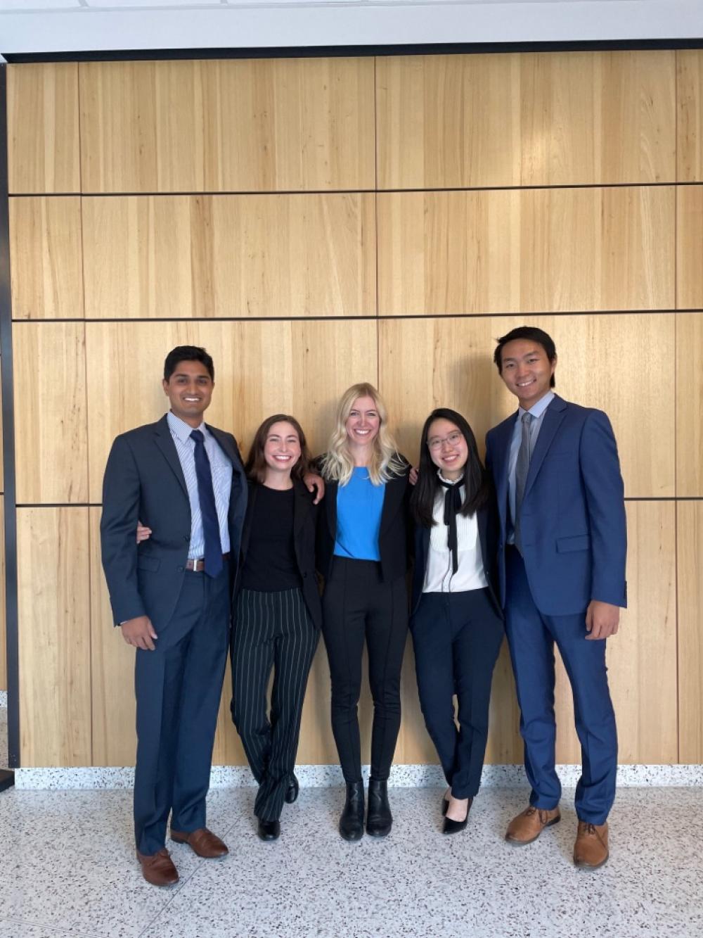 the five members of Scheme Team outside the McCombs graduate school building at UT Austin