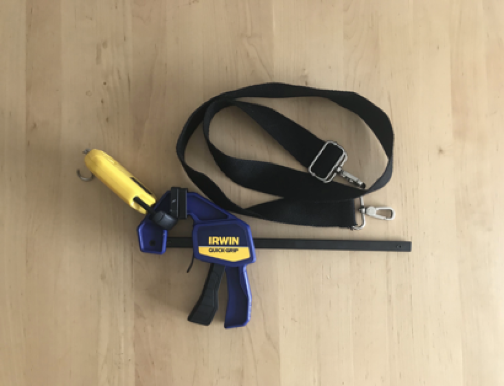 Trigger action clamp prototype parts, including: a trigger-action clamp, a luggage scale, and a hook and loop strap.
