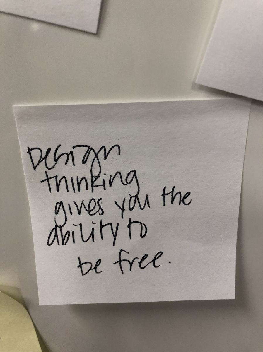 sticky note with handwriting that reads Design Thinking gives you the ability to be free.