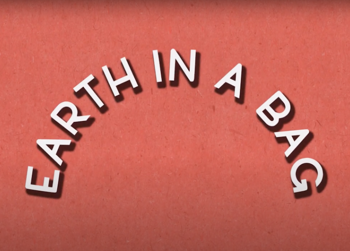 Red title slide with off-white text that reads "Earth in a Bag." words are curved like a rainbow
