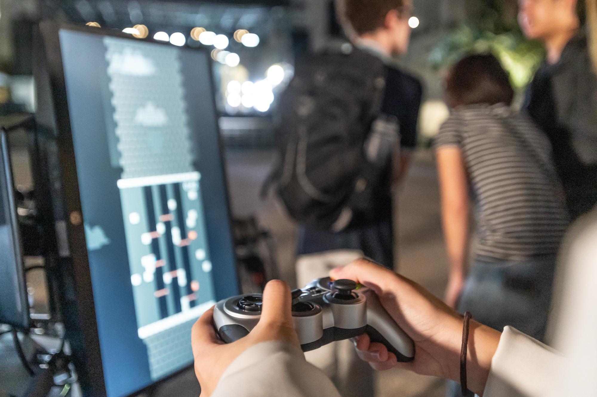 Students use game controller to play Tower projection game