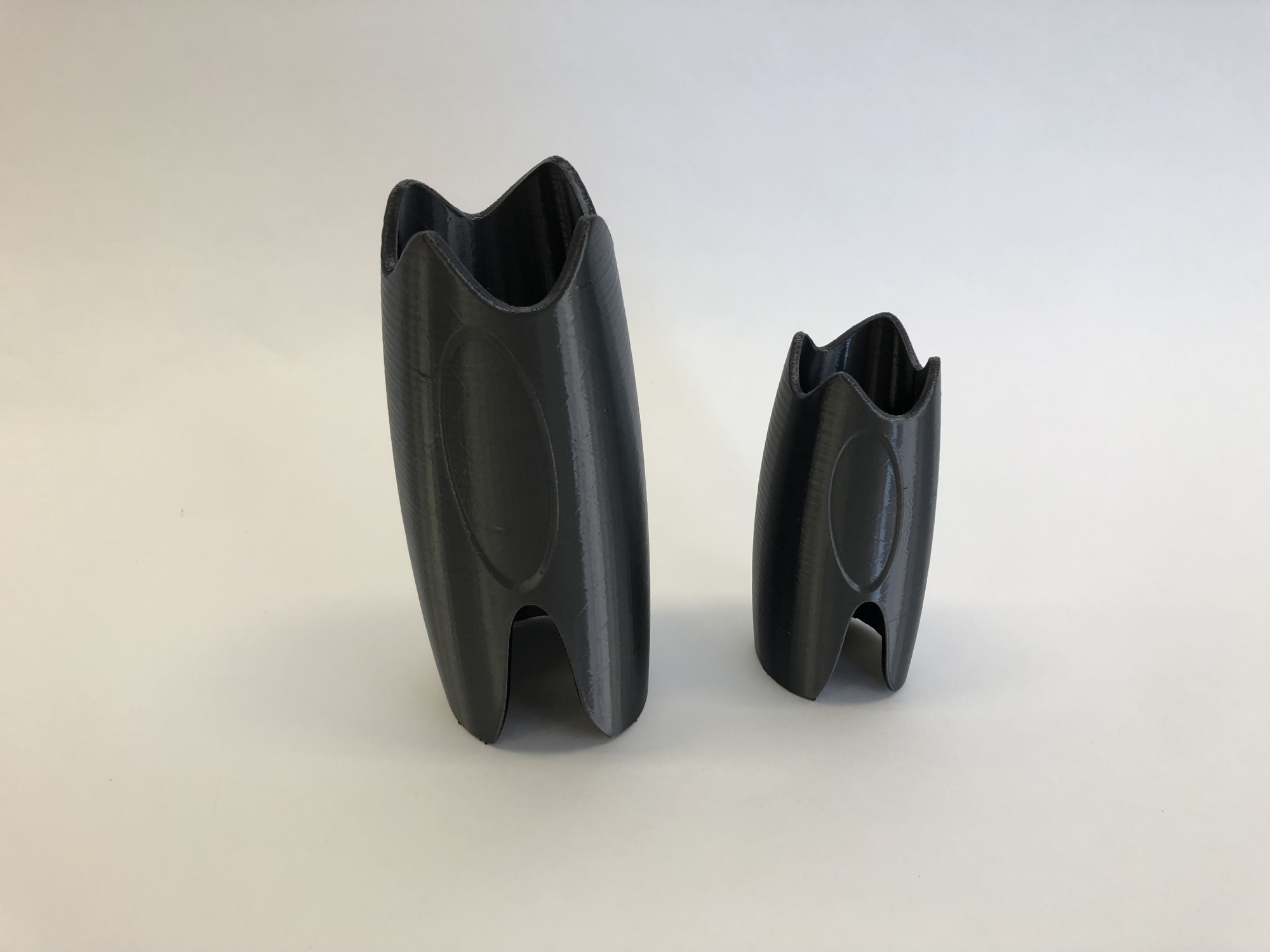 3D printed black prototype of MyKid-netic child surveillance device designed by Chloe Kim