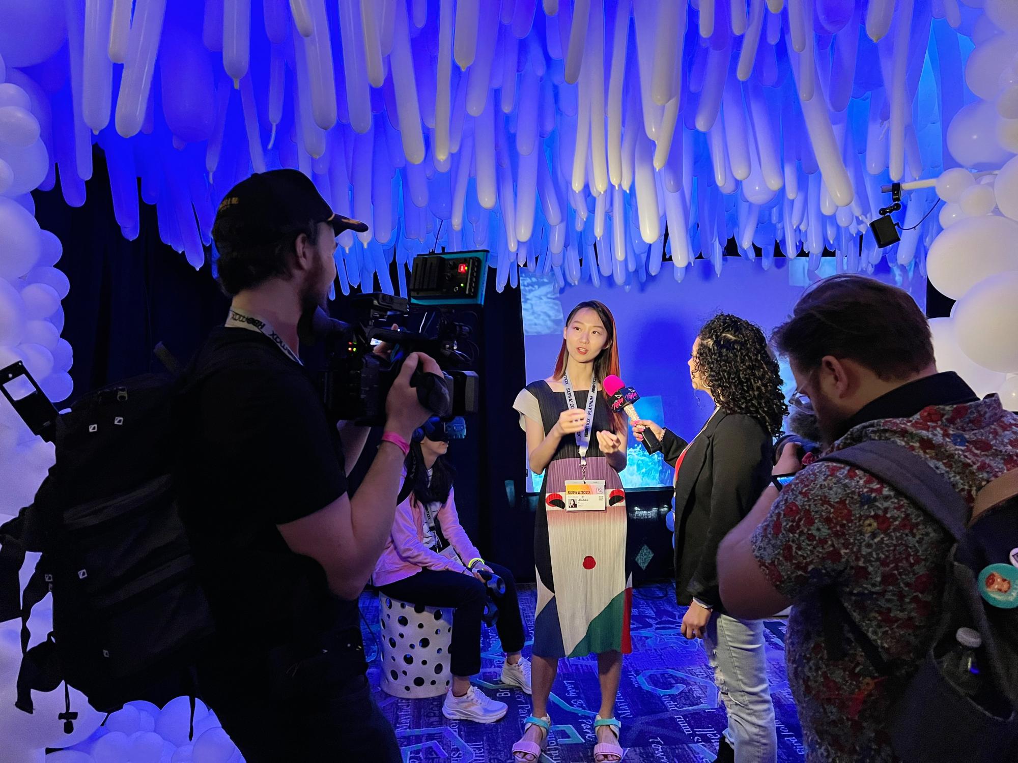 Assistant Professor of Design Jiabao Li being interviewed by press at South by Southwest 2023 about her Once a Glacier XR experience