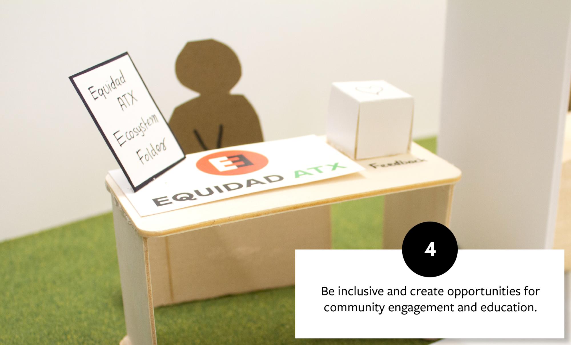 Model of a community engagement desk with an Equidad ATX sign, fostering inclusivity and opportunities for education and community involvement.