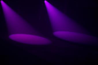 two purple spotlights create cone shapes on the floor