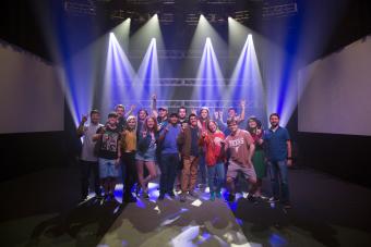 students show the UT hook em sign in a concert lighting demo room