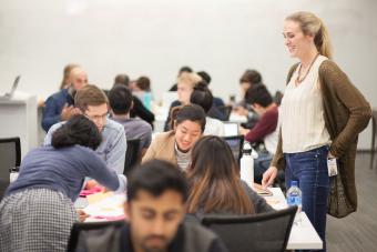 Students working on a project with a supervisor from IBM during an off-site course offered as part of the Bridging Disciplines Program in Design Strategies