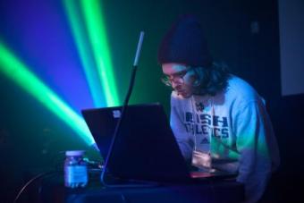 a student standing at a VJ lighting booth