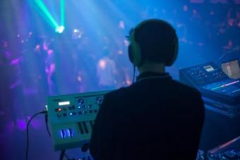 A student wearing headphones and running a lighting board