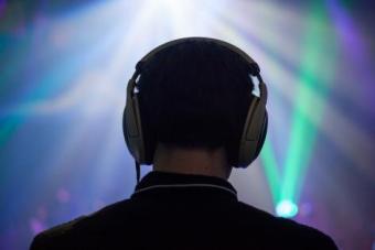a close up of the back of a student's head, wearing headphones 