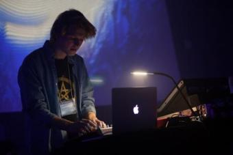 a student working a light show through their computer 