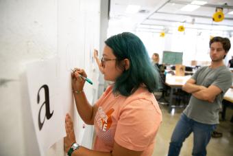 Student in Professor Kelcey Gray's Typography I class free-drawing the letter "a"