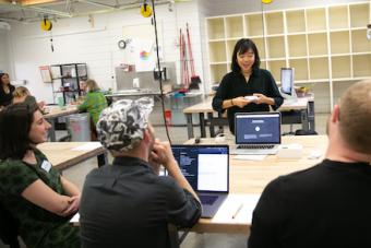 B.F.A. Design senior presenting her capstone project at mid-year review in the ART Building on UT Austin campus