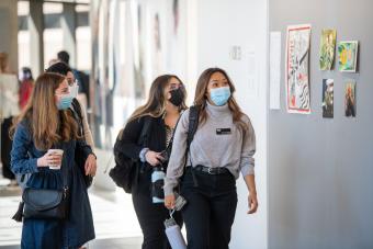 M.A. in Design focused on Health students walking through the halls of the Health Transformation Building at Dell Medical School