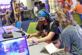 Arts and Entertainment Technologies students playing an original video game presented at the Level Up showcase event in May 2022