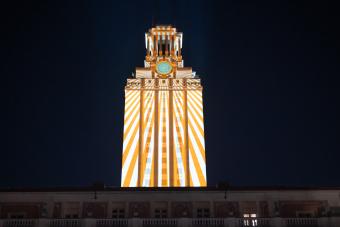 Wide angle shot of the iconic University of Texas Tower with live projection mapping designed by students and faculty in the School of Design and Creative Technologies