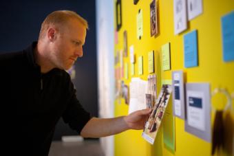 A man interacting with an M.F.A. Thesis Design project at the Spring 2019 public exhibition.