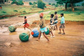 Young people purifying water while walking using Hippo Rollers