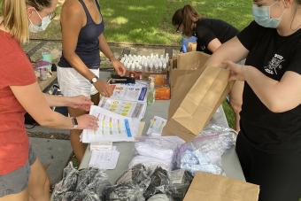 researchers from the Design Institute for Health hand out COVID-19 safety kits to community members from affordable housing in East Austin