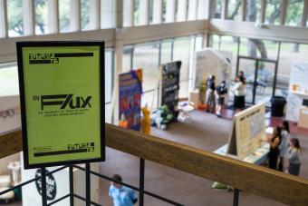 Poster for In Flux senior design capstone exhibition at Future 23 showcase with exhibition in the background