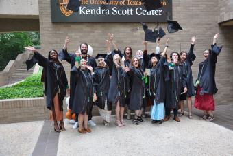 Master of Arts in Design focused on Health Class of 2023 graduates tossing their graduation caps in the air outside the Kendra Scott Center
