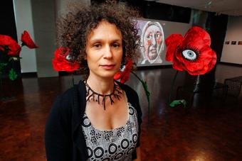 AET professor Yuliya Lanina posing in front of new multimedia installation Mother Land on view at the Austin Public Library