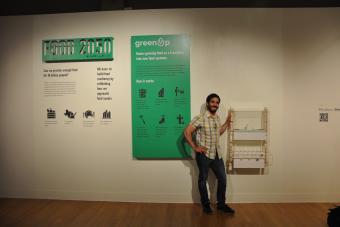 2022 MFA Design graduate Guillermo Jesus de Leon Perez posing next to his exhibition Food 2050