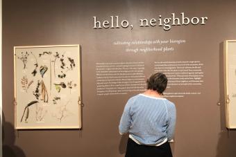 Image of Over Under 2022 MFA exhibition attendee interacting with Hello Neighbor installation
