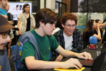 AET Students looking at a laptop screen