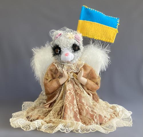 image of Yuliya Lanina handmade sculpture of a squirrel-like animal in a dress holding the Ukrainian flag