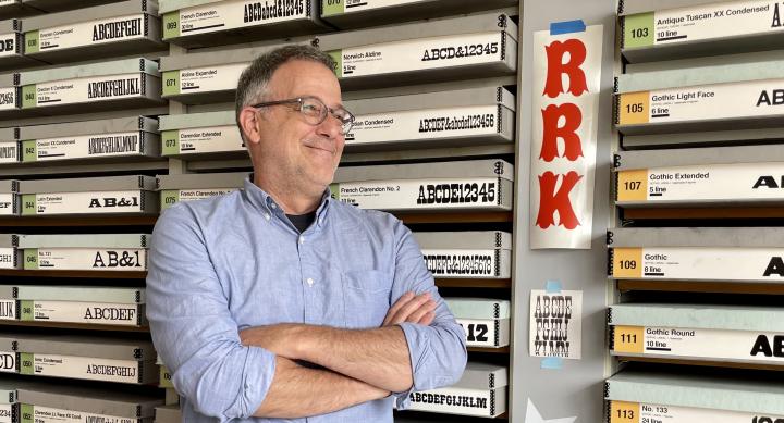 David Sheilds posing in front of the Rob Roy Kelly American Wood Type Collection during his visit in Fall 2023