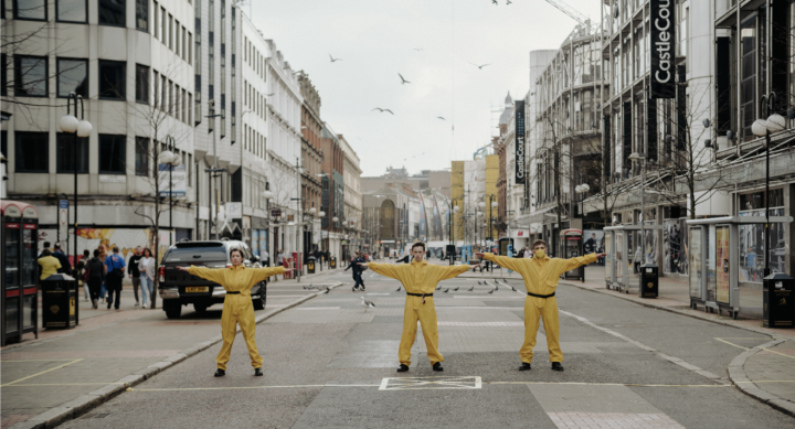 Performers occupying Royal Avenue at the location of a drop arm barrier that permitted buses through the center and secured the space between two checkpoints