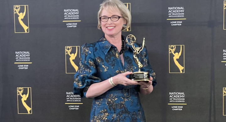 AET lecturer Natasha Davison holding her Lone Star EMMY Award for producing writing and directing the Muraling Austin series